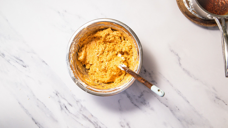 Spatula inside bowl of Nashville hot chicken dip