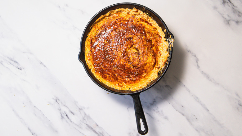 Unbaked Nashville hot chicken dip with hot paste on top