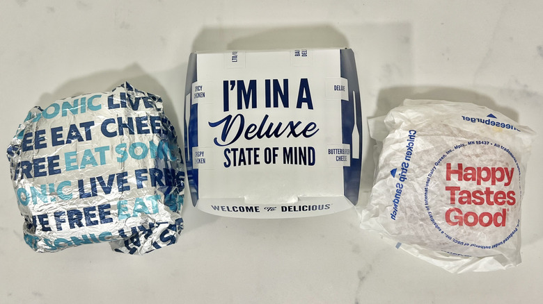 Culver's, Sonic, and Dairy Queen cheeseburgers in to-go boxes and wrapping.