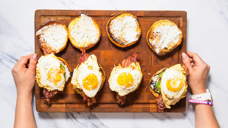 Assembled breakfast burgers on cutting board