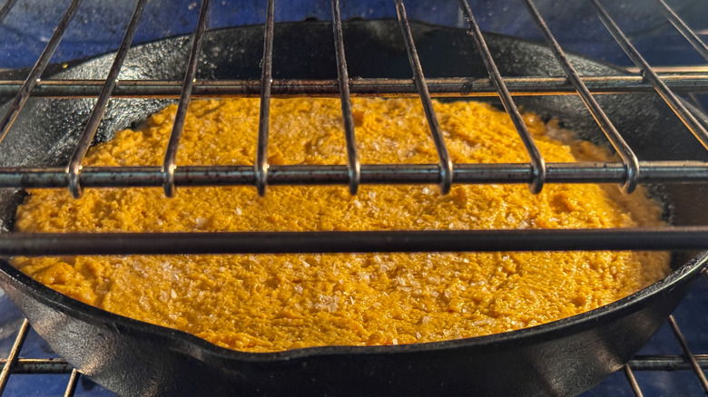 Pumpkin cornbread in skillet in ove