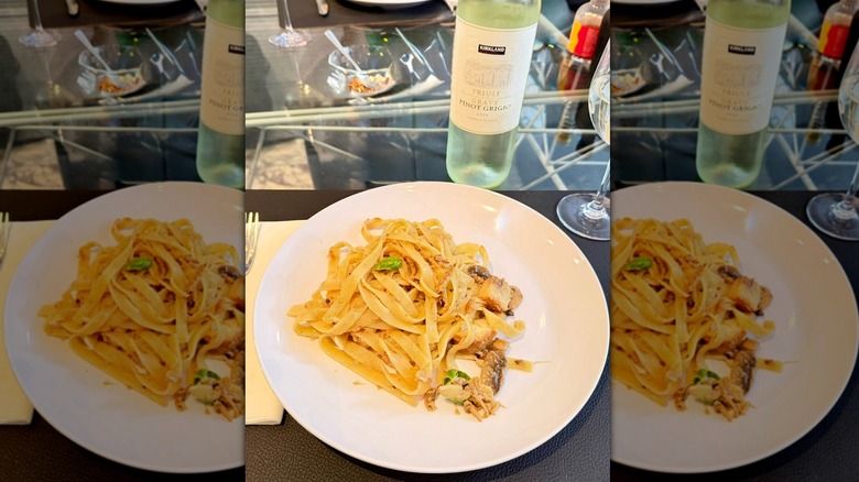 Bottle of Kirkland Signature Pinot Grigio Friuli Grave with plate of pasta