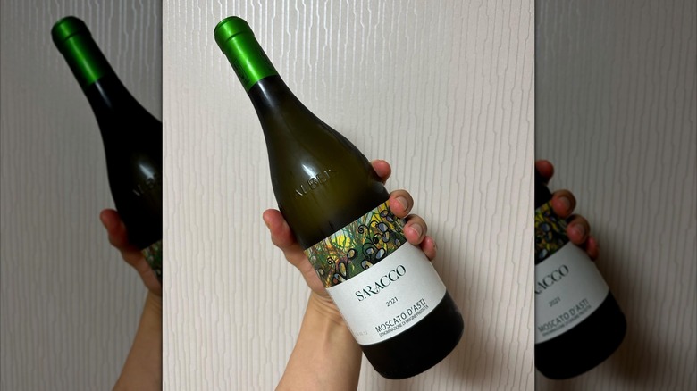 hand holding wine bottle
