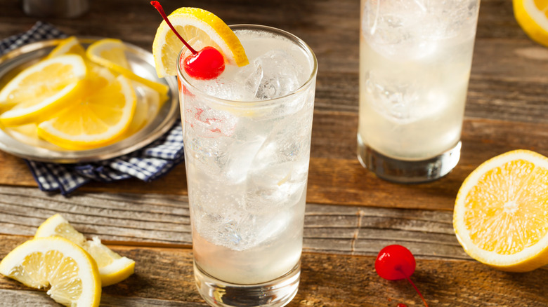 Tom Collins gin cocktail with lemon slices and cherry