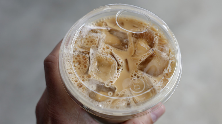 Hand holding iced coffee from Dunkin'