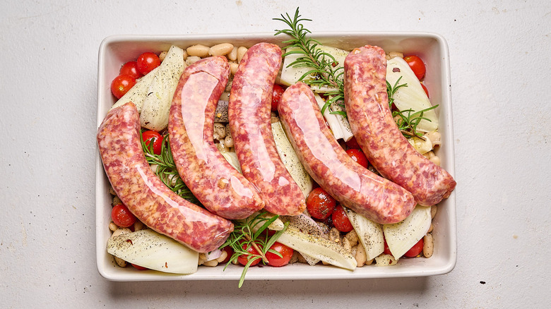 sausages added on top of tomatoes