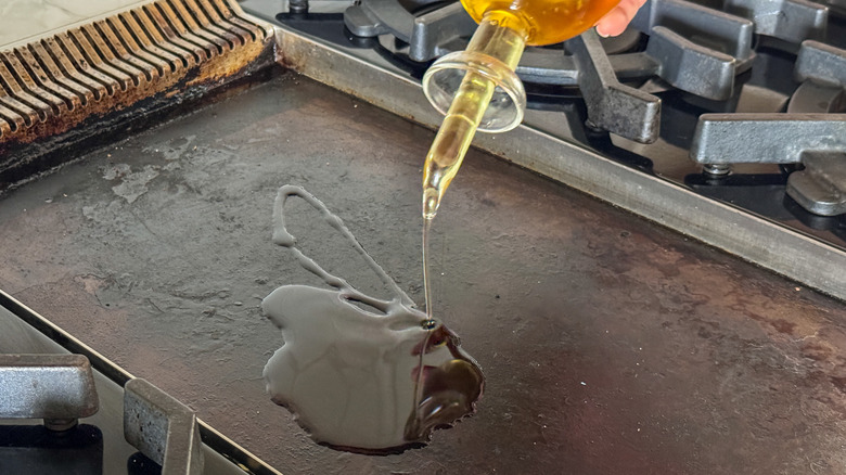 adding oil to griddle