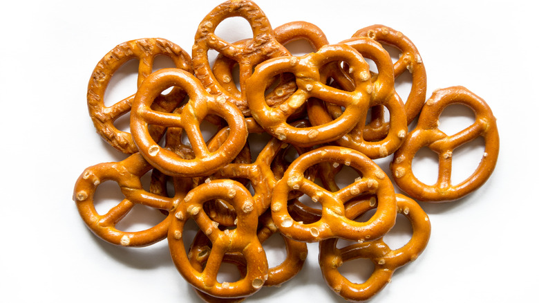 Pile of twisted pretzels on white surface