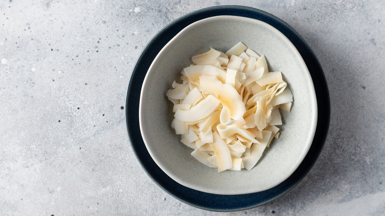 Toasted coconut in small white bowl