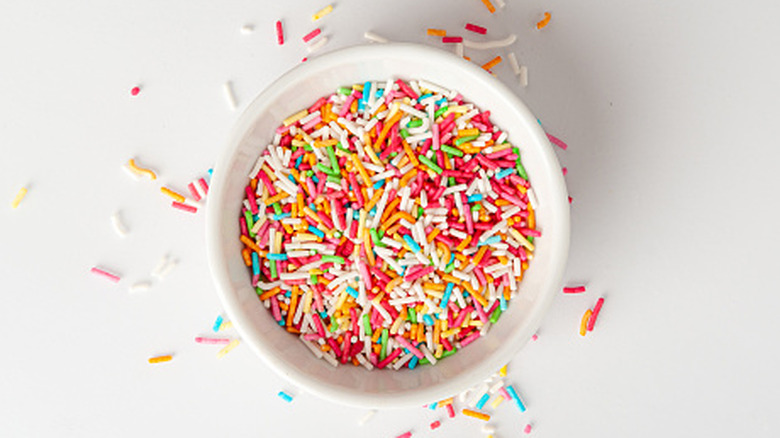 Bowl of colorful sprinkles on table