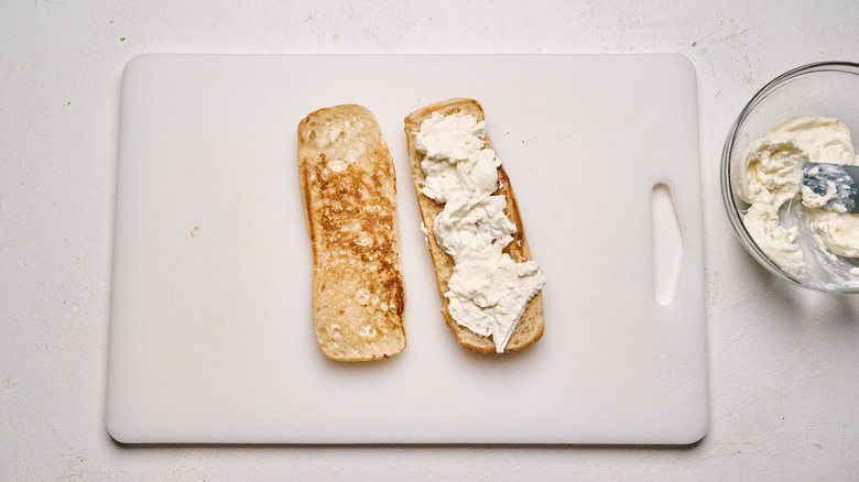 toast spread with burrata on a cutting board