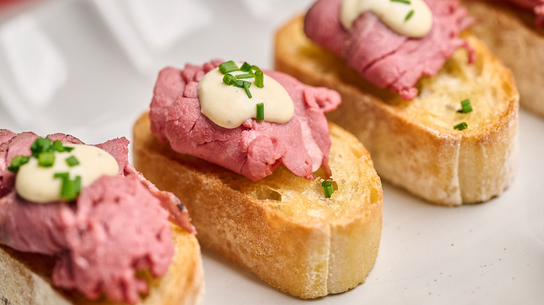 beef and horseradish crostini on a platter