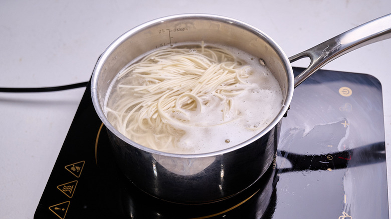 cooking noodles in a pot of water
