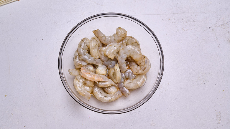 marinating shrimp in a bowl