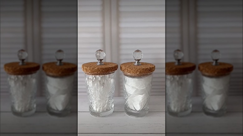 Two glasses with cork lids.