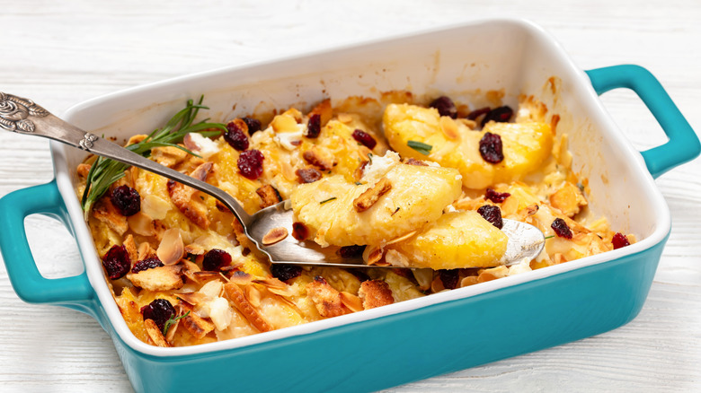 A baked pineapple casserole in a blue ceramic dish