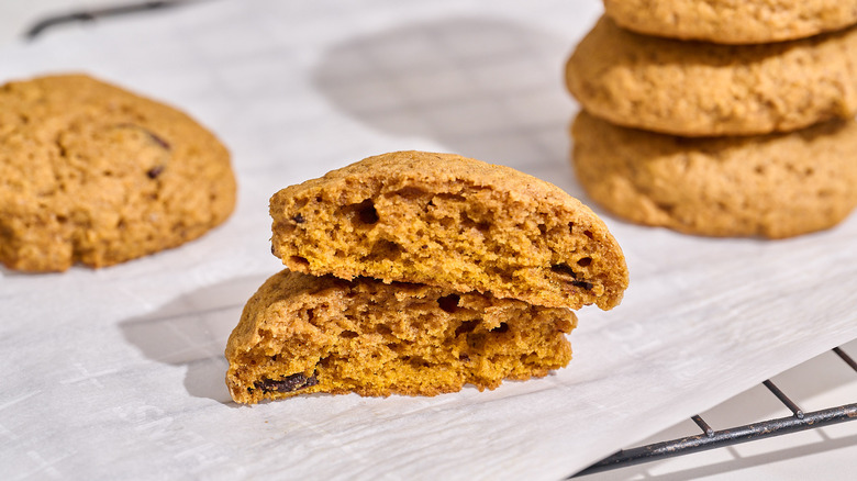 pumpkin cookie broken in half on a wire rack