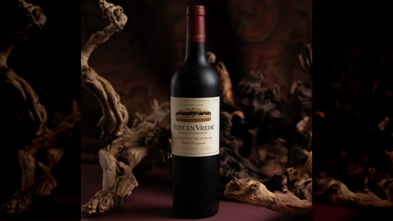 hand holding bottle of Los Vascos red wine