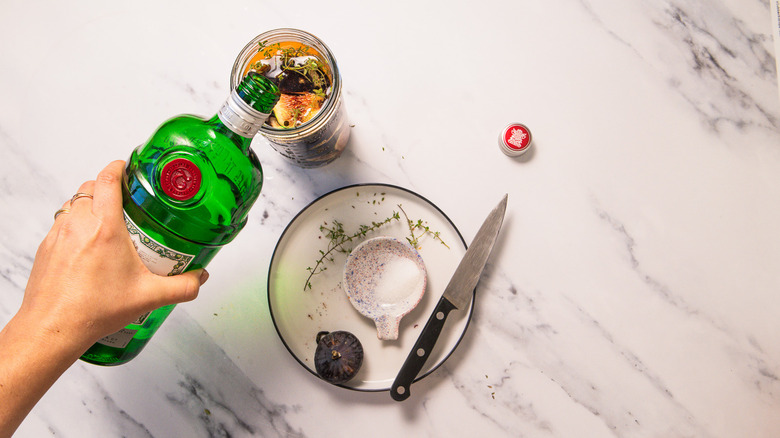 Adding gin to jar