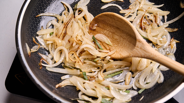 cooking onions in a skillet