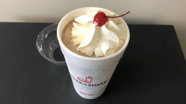 Steak 'n Shake chocolate milkshake with whipped cream and a cherry on top
