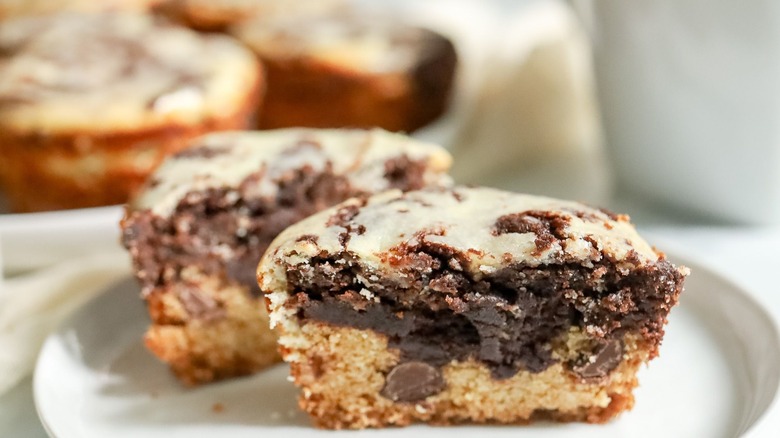 Cheesecake brookie muffin halved on plate
