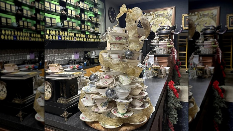 Precarious stack of teacups on counter of tea bar