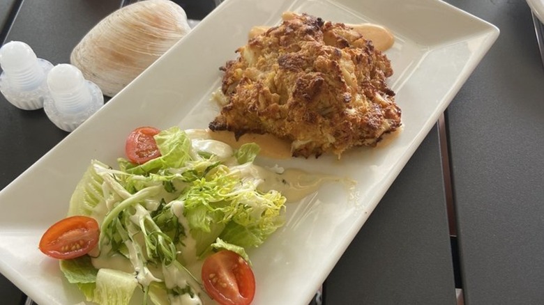 Crab cake on rectangular plate with salad