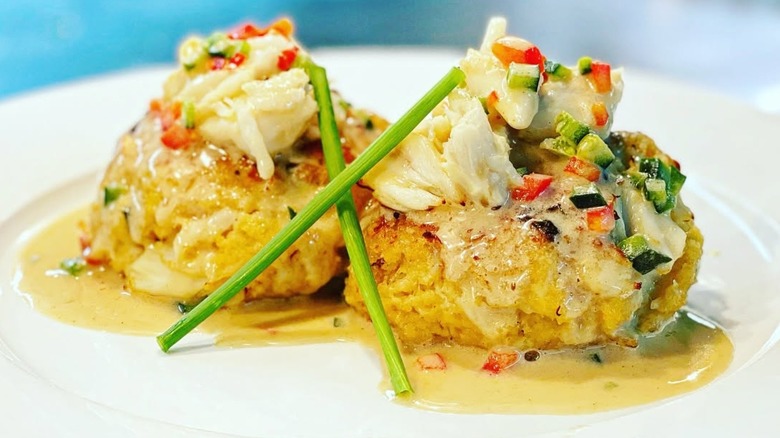Two crab cakes with sauce