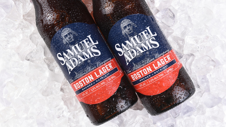 Two bottles of Samuel Adams Boston Lager sit on ice.