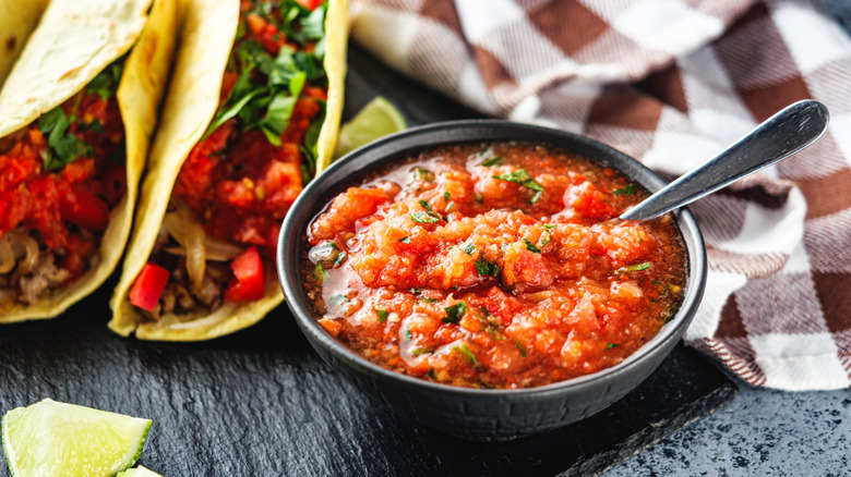 Steak tacos with bowl of spicy salsa