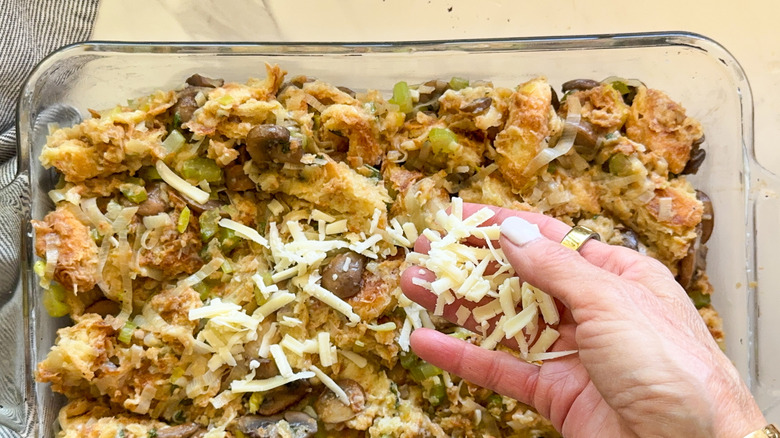 hand adding the cheese